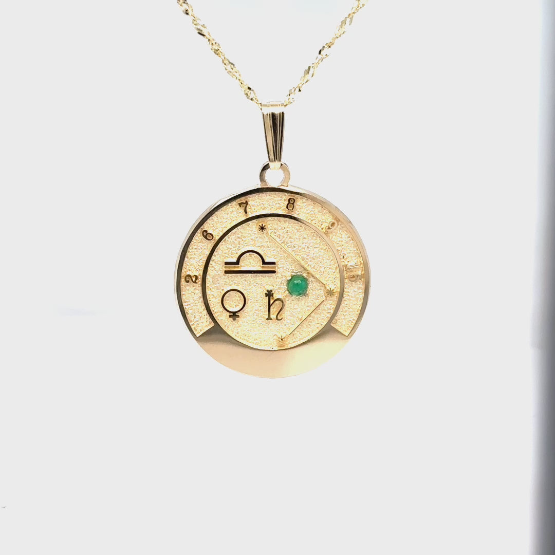 Video showcasing the 14k gold Libra talisman pendant design, details, and emerald gemstone.