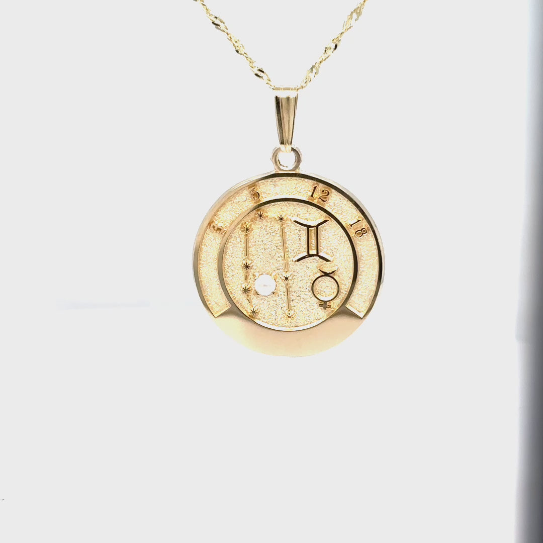 Video showcasing the 14k gold Gemini talisman pendant design, details, and topaz gemstone.